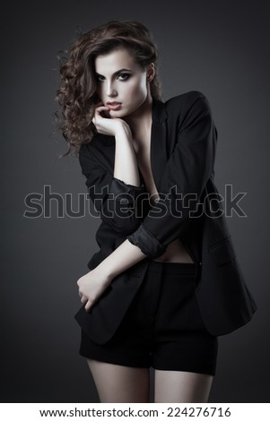 Fashion shoot of young woman in black jacket and shorts
