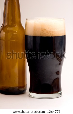 Brown Ale in Pint Glass with Empty Beer Bottle