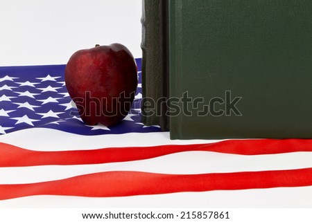 Symbols of learning; schools; and education placed with American flag.; Red apple, books, and national symbol reflect Board of Education, Core Curriculum, government policy, and critical skills.