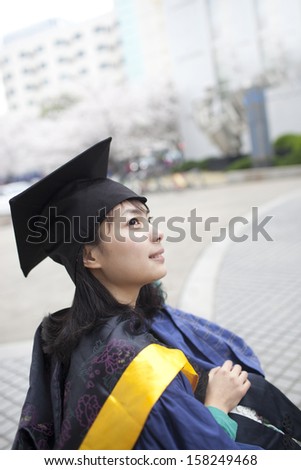 Asian female graduate looking forward for future in campus