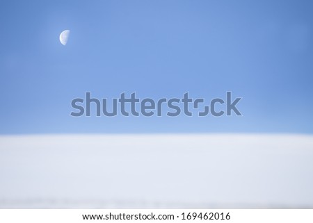 half moon over snow roof in winter