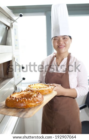 Female asian chef cooking bread at home