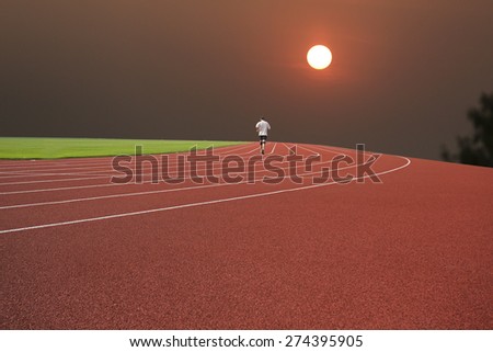 asian people running on tract in sunset