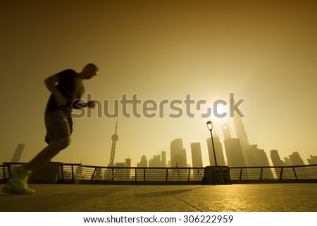 People running at Shanghai bund in the morning,landmark of Shanghai