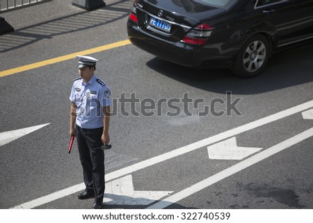 Shanghai,China-September 26,2015:Traffic police were directing traffic in the Lujiazui street where is the finance center area of Shanghai,China