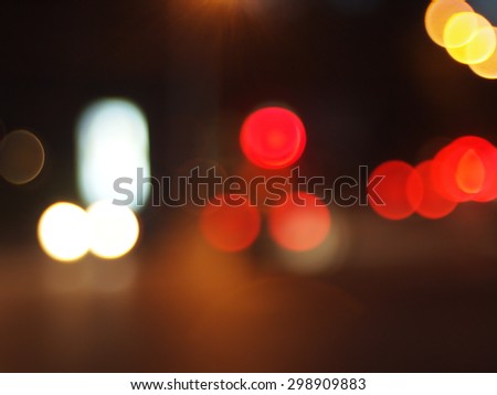 Defocused lights from the headlights and tail lights of cars on the road was blurred for use as a background