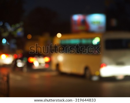 Abstract and blur night scene with bus and headlights. Blur and defocused lights from the headlights of cars and traffic lights can be used as background.