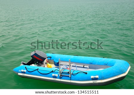 blue inflatable boat on the water