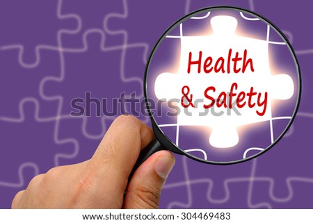 Health and safety word. Magnifier and puzzles.