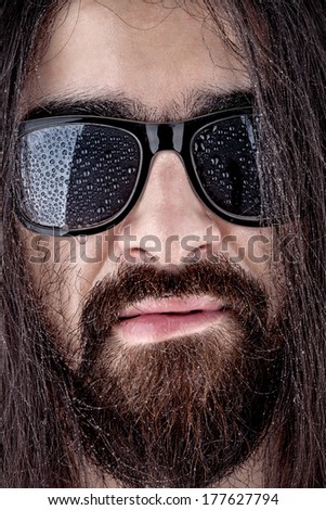 Wet face of a man in sunglasses
