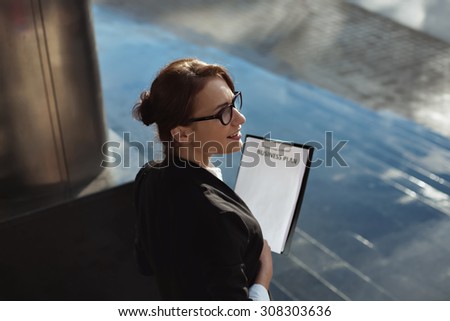 Business people concept- city business woman working. Shot of business lady manager with business plan documents on outdoors background.