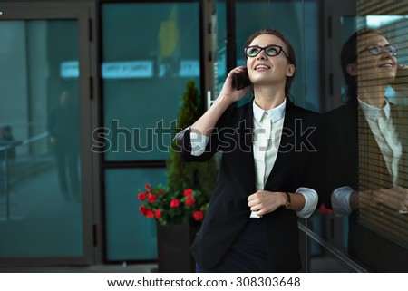Business woman talking on smart phone on office terrace. Beautiful business people office worker talking on smartphone smiling happy.