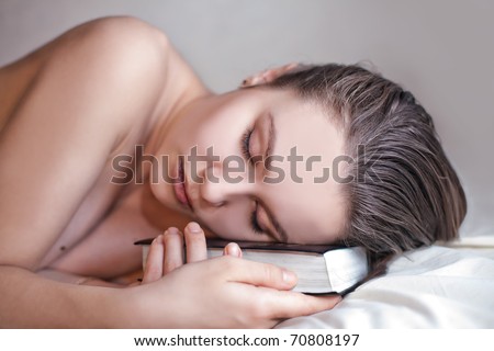 beautiful woman sleeps with the book