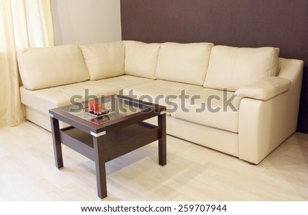 Modern white corner leather sofa and coffee table.