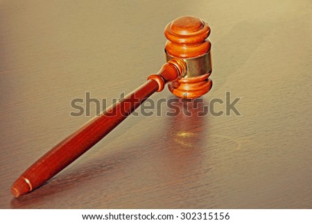 Judge gavel on wooden table in court.