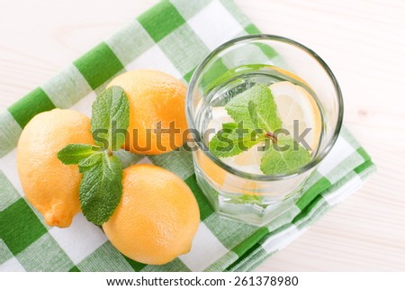 water with lemon and mint in a glass on  table top viewew
