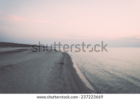 beach after the sunset with sand and clouds - retro, vintage style look