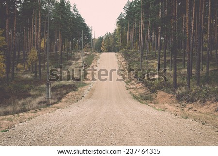 country gravel road in the forest. latvia. - retro, vintage style look