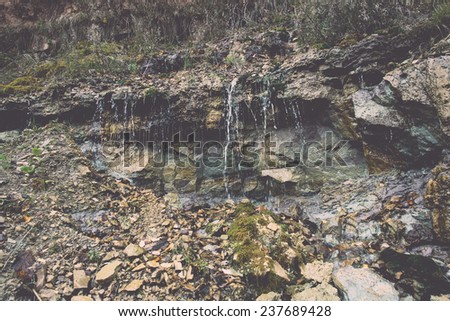 sandstone cliffs with water source. latvia. - retro, vintage style look