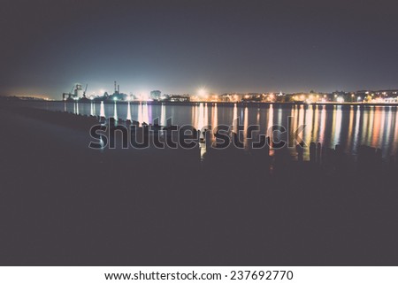 city light reflections over water at the night - retro, vintage style look