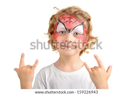 Beautiful young boy with face painted with a spider web
