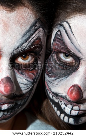 Teenage girls with scary clown face painting