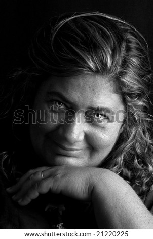 Beautiful clear eyed woman with hat posing against a black background