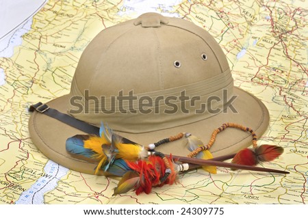 Explorer's hat and feathers over map