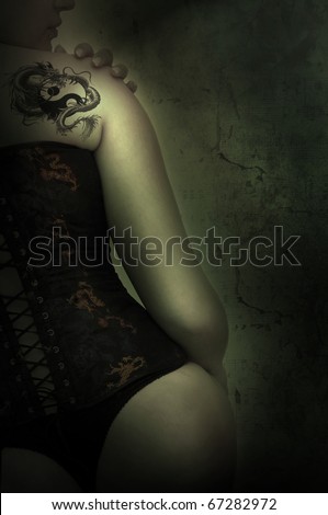 Sexy woman with corset and dragon tattoo in a grunge background