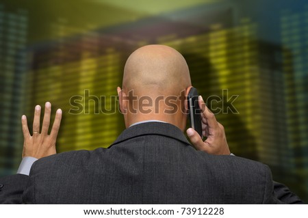 Businessman or stock broker at the phone in stock exchange