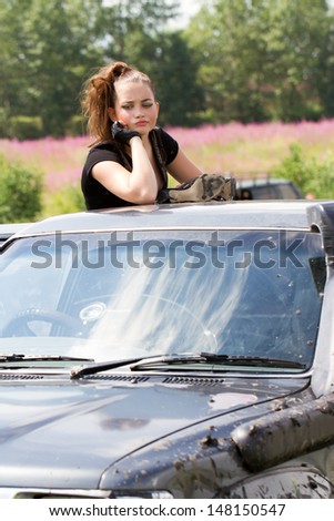 Girl trying to get out of the car got stuck in the mud