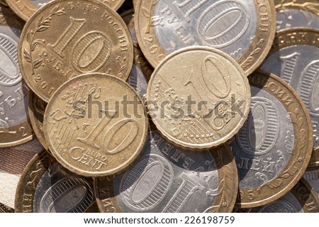 Coin worth ten cents on the euro coins against ten rubles
