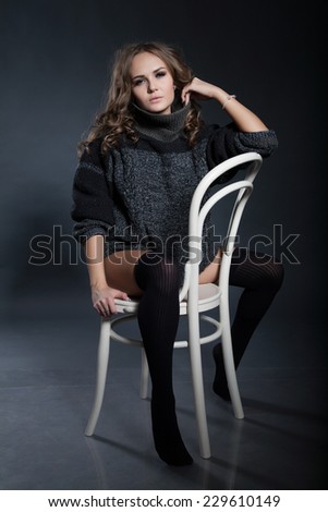 girl sits on a chair