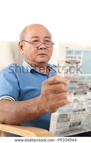 Asian senior man reading newspaper on white background