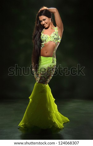 beautiful girl dancing in a green dancing dress