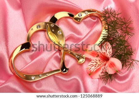 gold hearts frame with flowers on pink satin