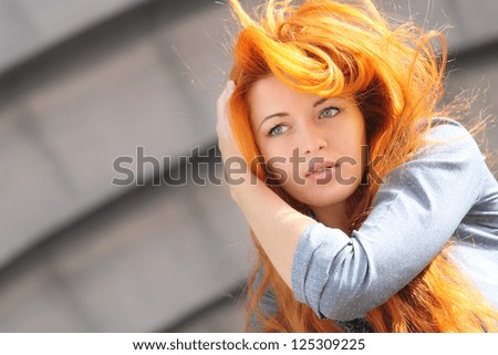 beautiful girl with red hair in the park
