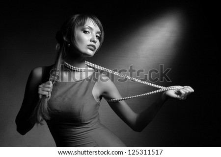 Girl with necklace in an erotic manner