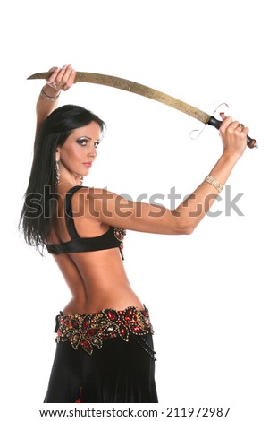 beautiful woman dancing in colorful Arabic dance costume. beautiful brunette. long hair .dance with saber.