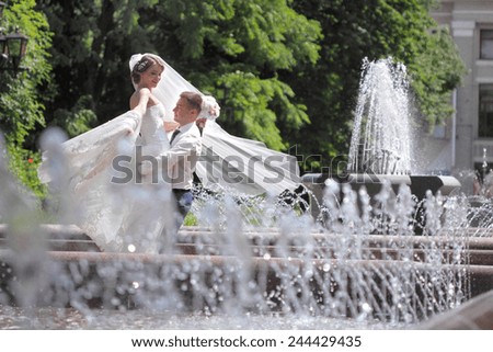 bride in the park near the fountain. happy emotions. the dance moves