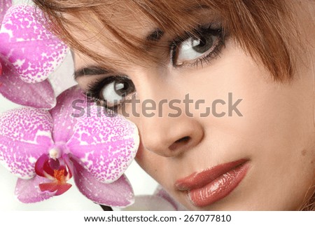 portrait of a woman with a flower in hair. fashion makeover. sexy lips. sensual look, bright smile. groomed skin