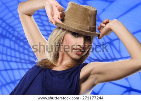 young beautiful woman in hat . flirty look. Game emotions. beautiful figure . photo on the background of the web