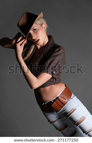 portrait of a young dancing girl with hat . flirty look. Game emotions. beautiful figure