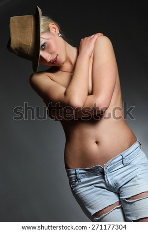 portrait of a young dancing girl with hat . flirty look. Game emotions. beautiful figure