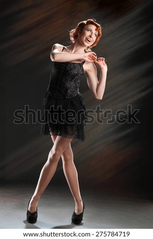 active, beautiful girl in the studio shooting . stylish hairstyle and make-up, bright emotions