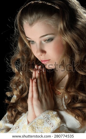 young woman in prayer to God. good wavy hair. family values. belief in a happy life