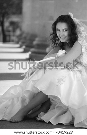 black and white portrait of a bride in theater columns