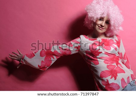 portrait of a young girl with pink hair pink background