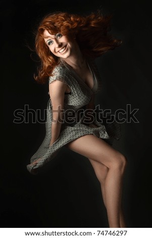 red-haired, blue-eyed girl in an emotional flight with the wind from the developing hair