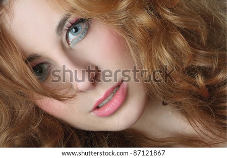 Portrait of a red-haired, blue-eyed girl on white background